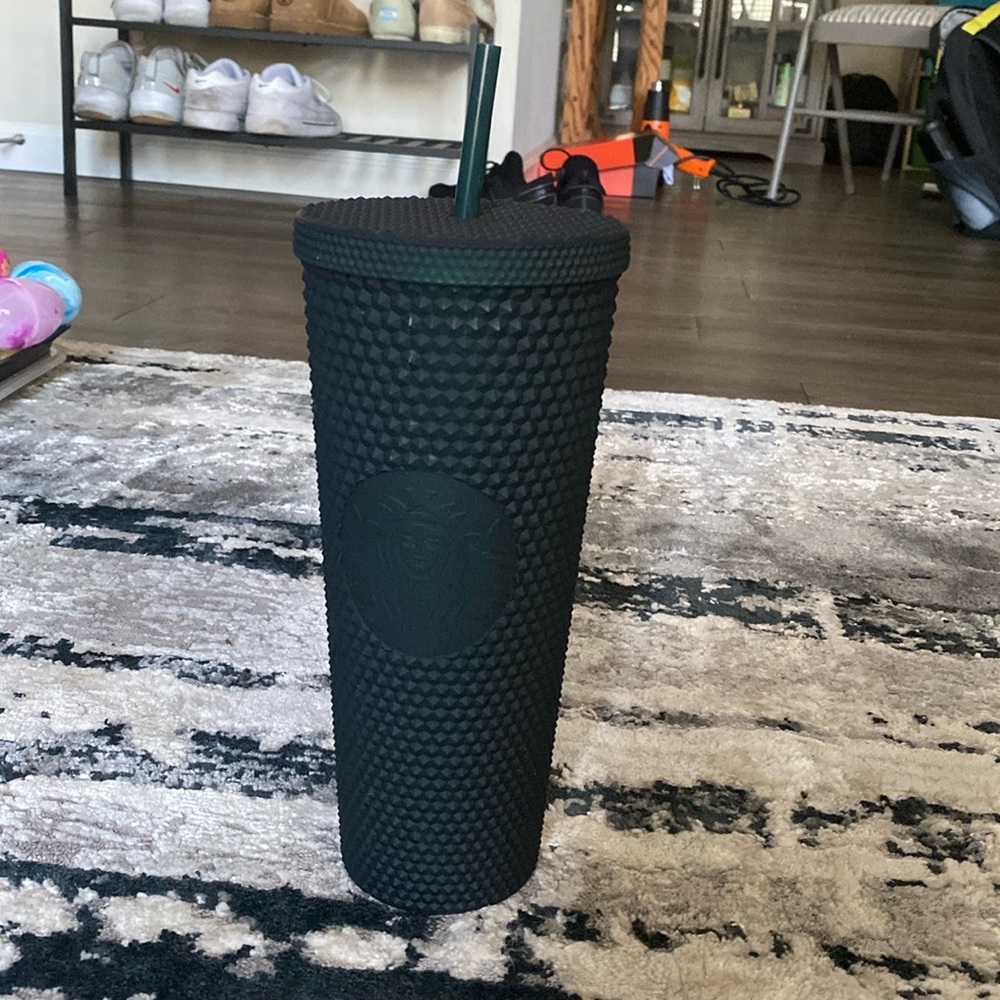 Green studded Starbucks cup